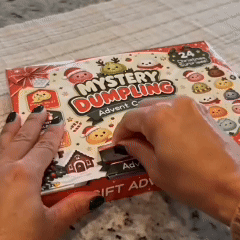 Hands opening the Christmas Mystery Dumpling advent calendar